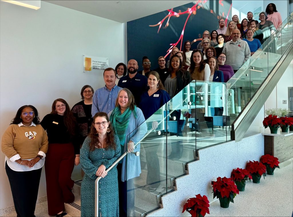 Individuals stand together on a staircase.