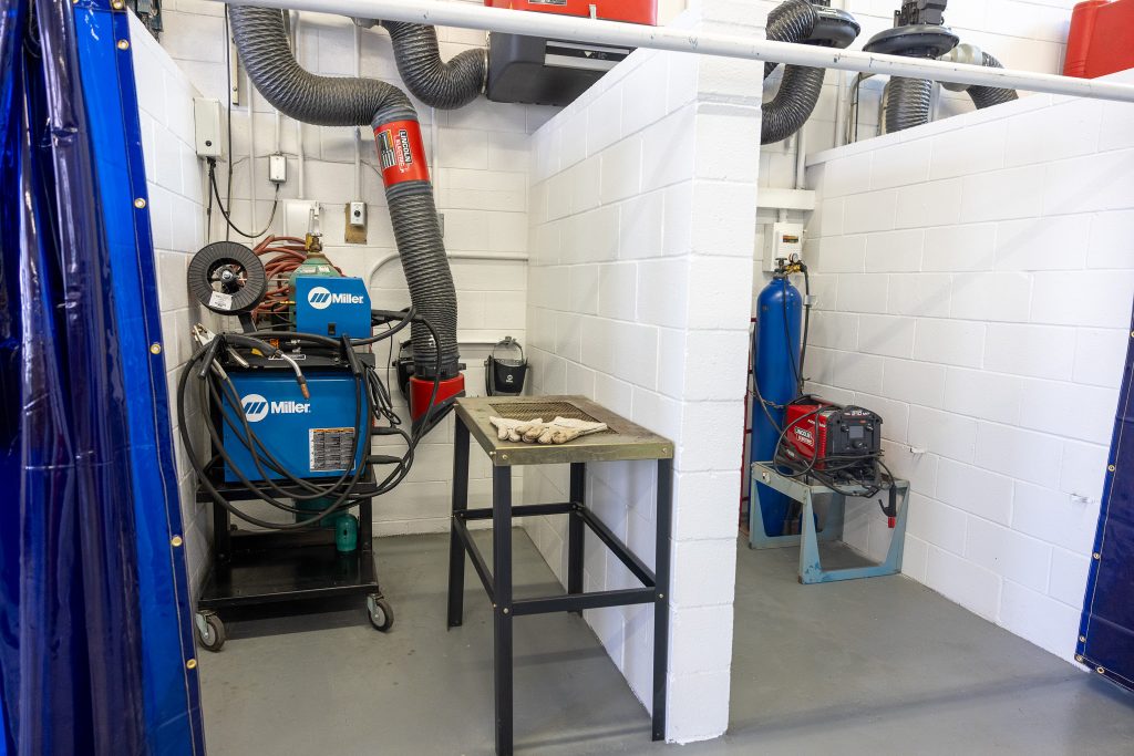 A welding booth containing equipment is shown.