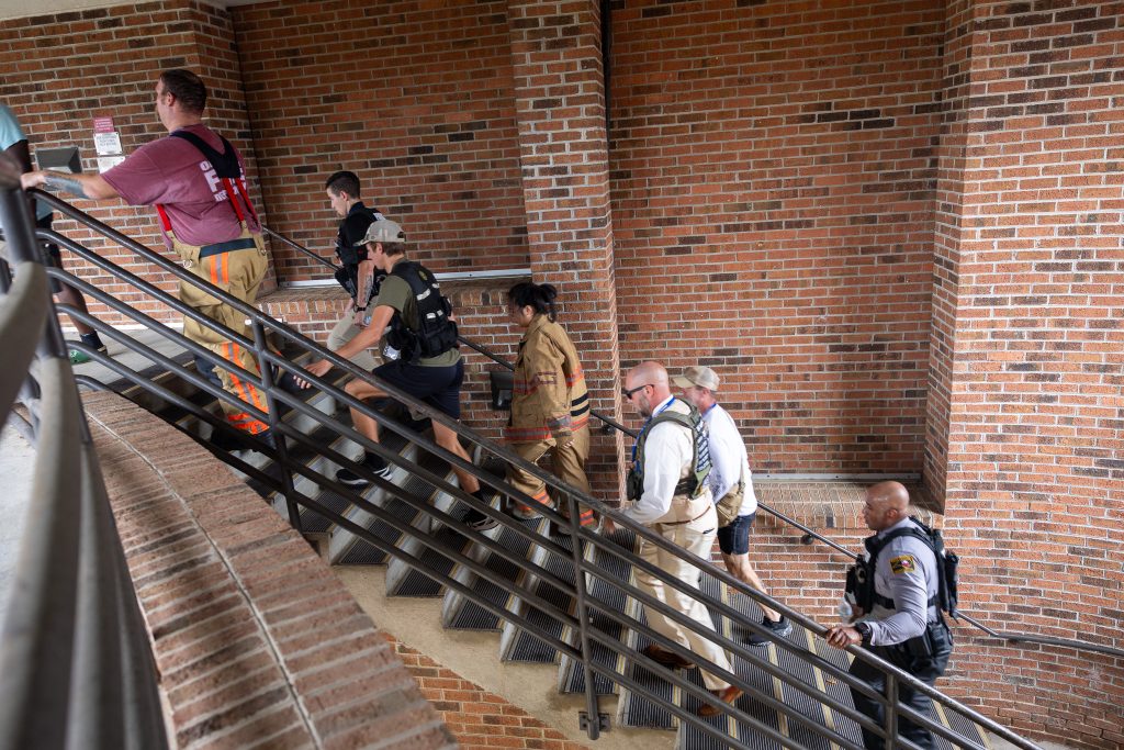 Individuals climb stairs.