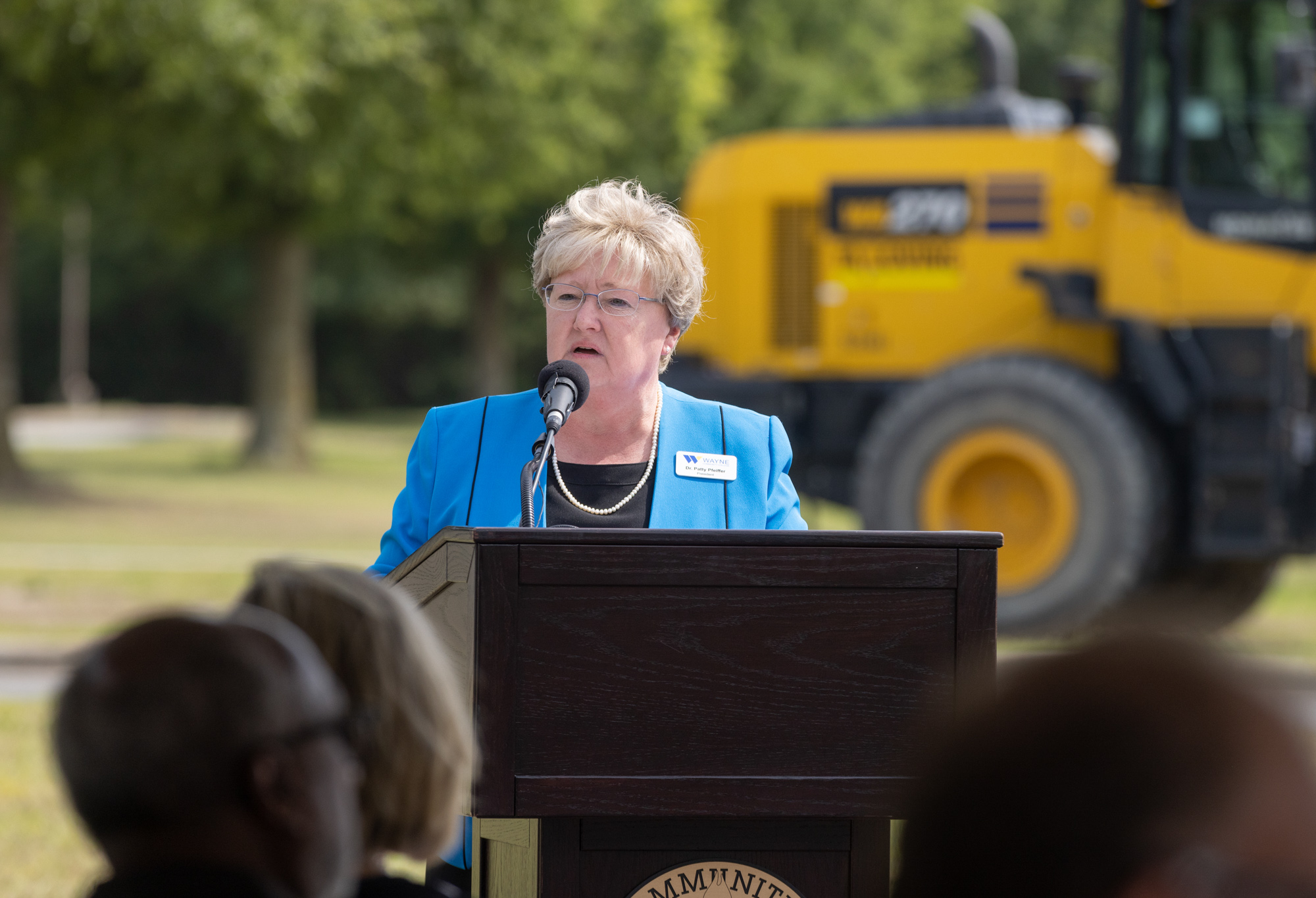 Woman speaks to crowd from a podium.