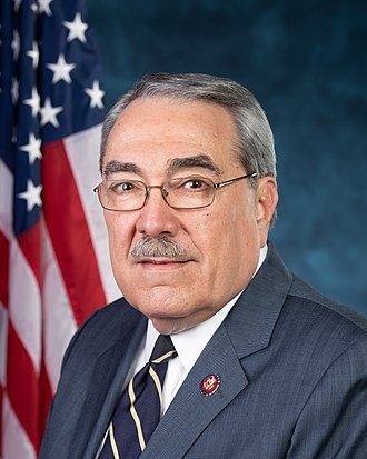 Man sitting in front of an American flag