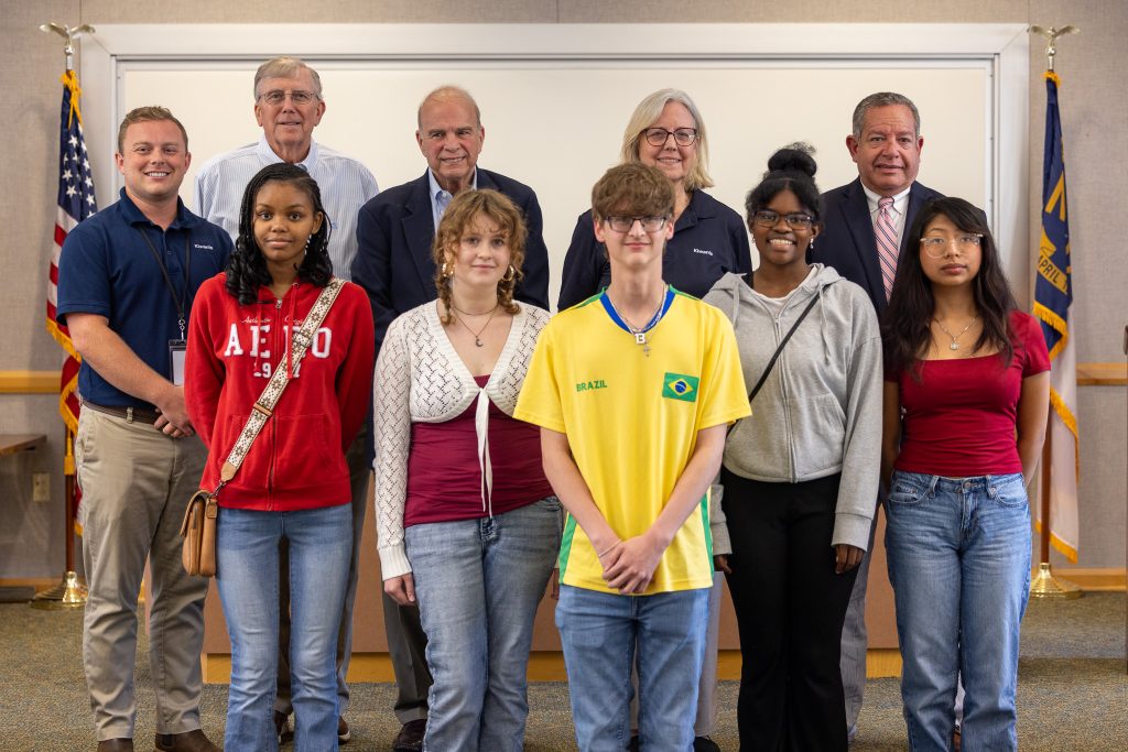 A group of individuals stand together.