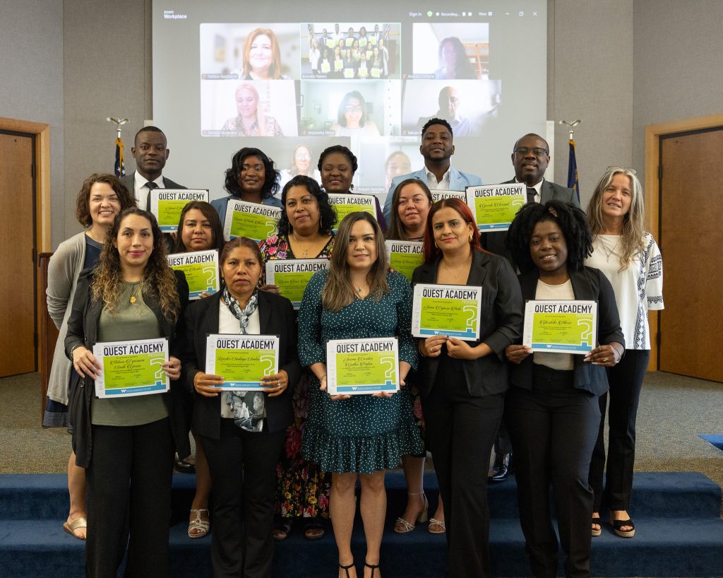 Students stand together holding certificates.