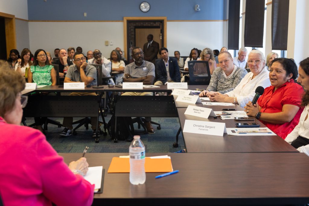 Individuals sit around a table.