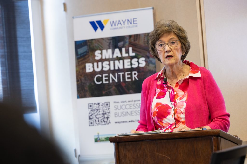 A woman speaks at a podium.