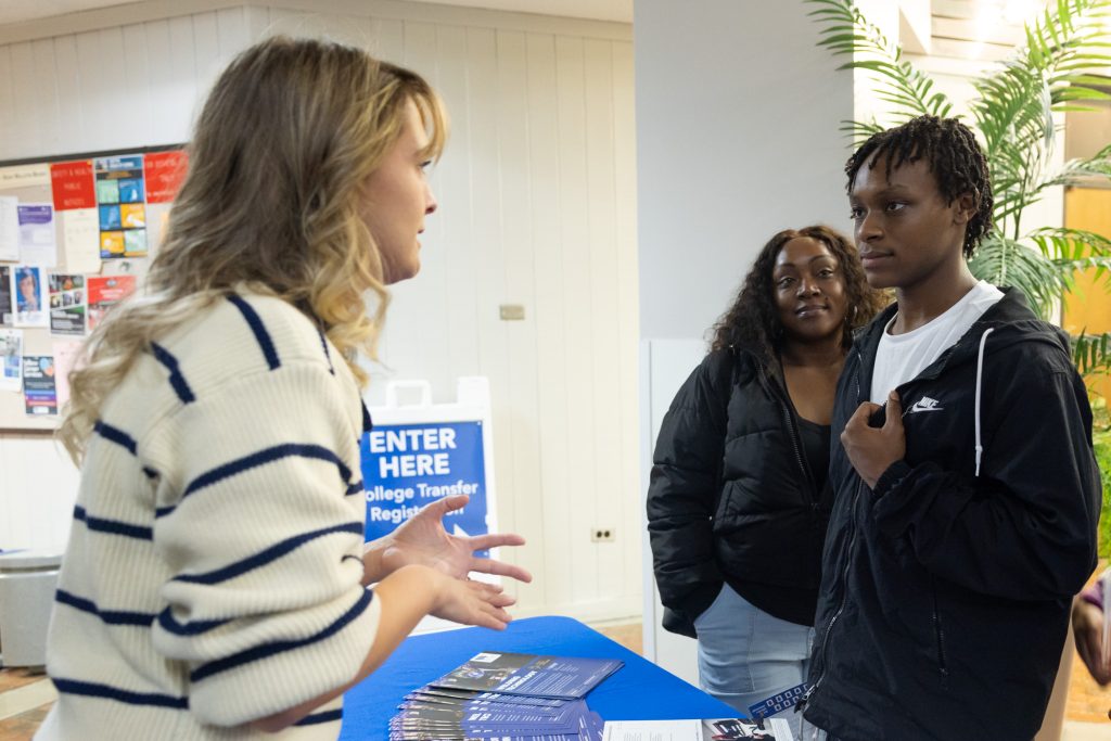 A woman talks to a student.