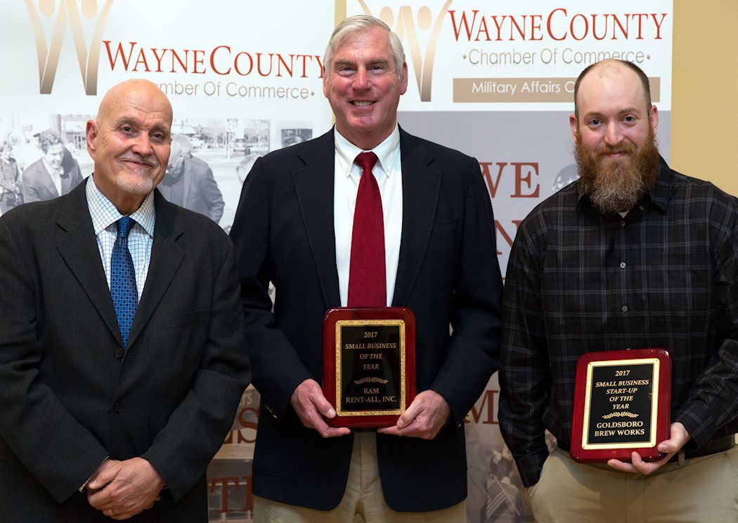 2018 Small Business Award winners stand with their plaques beside the Small Business Center director.