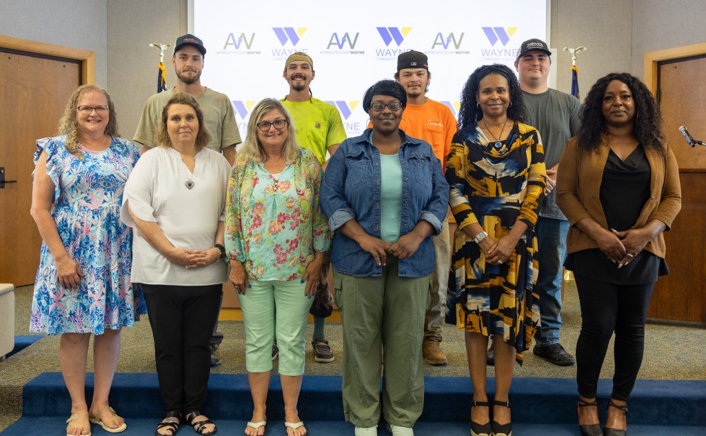 A group of individuals stand together.