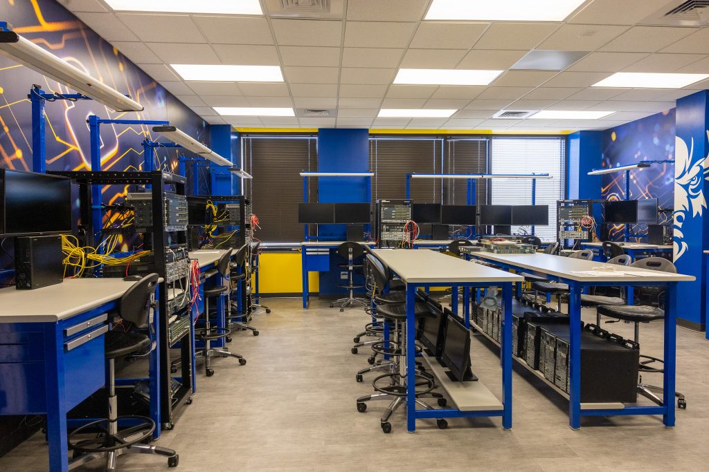 A room is shown with work stations.