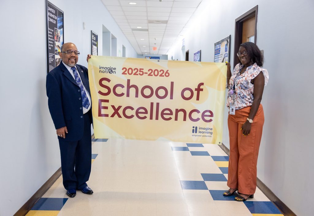 Two individuals hold a banner between them.